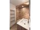 Bathroom showcasing a tile shower, white vanity and built in shelves at 2285 Peachtree Ne Rd # 1202, Brookhaven, GA 30309