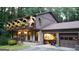 Charming home featuring brick facade, manicured lawn, and unique arched balcony with flower boxes at 4567 Town Crier Sw Rd, Lilburn, GA 30047