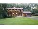Charming two-story home with landscaped yard, brick facade, and unique arched balcony at 4567 Town Crier Sw Rd, Lilburn, GA 30047