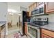 Kitchen area featuring stainless steel appliances, light wood cabinets and tile floors at 12303 Waldrop Pl, Decatur, GA 30034
