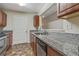 Galley style kitchen features granite countertops, stainless steel appliances and tile flooring at 12303 Waldrop Pl, Decatur, GA 30034