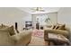 Inviting living room with plush seating, a ceiling fan and a large window for natural light at 12303 Waldrop Pl, Decatur, GA 30034