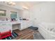 Bright bathroom with double sinks, a soaking tub, decorative lights, and wood-look flooring at 304 Bennett Farms Ct, Acworth, GA 30102