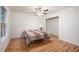 Bright bedroom with wood-look floors, a ceiling fan, and an open closet at 304 Bennett Farms Ct, Acworth, GA 30102