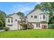Rear exterior view of home showing bay windows, back deck, and landscaped yard at 304 Bennett Farms Ct, Acworth, GA 30102