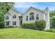 Two-story home featuring white siding, a stone accent, and a beautifully landscaped yard at 304 Bennett Farms Ct, Acworth, GA 30102