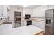 Well-lit kitchen with white cabinets, stainless steel refrigerator, and laminate countertops at 304 Bennett Farms Ct, Acworth, GA 30102