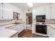 Bright kitchen with white cabinets, wood-look countertops, and modern appliances at 304 Bennett Farms Ct, Acworth, GA 30102