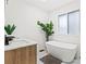 Luxurious bathroom featuring sleek freestanding tub, modern vanity, and large window for ample natural light at 951 Reed Ave, Atlanta, GA 30344