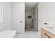 Bright bathroom features a vanity, large shower with glass doors, and elegant tiling for a sleek look at 951 Reed Ave, Atlanta, GA 30344