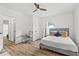 Bright bedroom with wood floors, ceiling fan, large bed, and desk setup for a great work from home space at 951 Reed Ave, Atlanta, GA 30344