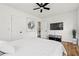 Bright bedroom featuring a ceiling fan, mounted TV, wood floors, and doorway to another room at 951 Reed Ave, Atlanta, GA 30344