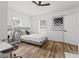 Bright bedroom features wood floors, a ceiling fan, a bed with accent pillows, and an art piece to add charm at 951 Reed Ave, Atlanta, GA 30344