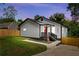Charming home featuring a red door, crisp white siding, a welcoming front porch, and well-maintained landscaping at 951 Reed Ave, Atlanta, GA 30344