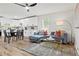 Open concept living room featuring a modern kitchen with dining area, a stylish gray sofa and elegant gold accents at 951 Reed Ave, Atlanta, GA 30344