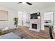 Comfortable living room featuring wood-style floors, fireplace, tv and a glimpse into an adjacent, cozy bedroom at 951 Reed Ave, Atlanta, GA 30344