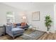 Stylish living room with a modern gray sofa, elegant gold accents, and a cozy rug for a welcoming atmosphere at 951 Reed Ave, Atlanta, GA 30344