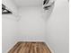 A walk-in closet with wood floors and metal racks offer functionality in a compact space at 951 Reed Ave, Atlanta, GA 30344