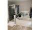 Bright bathroom with a shower, white soaking tub, and wood look floors at 4210 Chatham Ridge Drive Dr, Buford, GA 30518