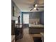 Comfortable bedroom featuring a ceiling fan, a bed with neutral bedding, and a desk for a functional workspace at 4210 Chatham Ridge Drive Dr, Buford, GA 30518