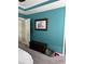 Comfortable bedroom with dark wood accents, carpeted floors, modern teal walls, and natural light at 4210 Chatham Ridge Drive Dr, Buford, GA 30518