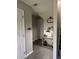 Well-lit entryway featuring a console table, modern lamp, decorative clock, and a staircase at 4210 Chatham Ridge Drive Dr, Buford, GA 30518