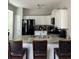 Bright kitchen with a breakfast bar, granite countertops, and ample cabinet space at 4210 Chatham Ridge Drive Dr, Buford, GA 30518
