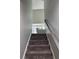 Carpeted staircase leading to the upper level with a sofa in the background at 4210 Chatham Ridge Drive Dr, Buford, GA 30518