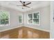 Inviting bedroom offers a ceiling fan, hardwood floors, and natural light from the two windows at 5575 Julian Pl, Atlanta, GA 30342