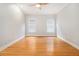 Comfortable bedroom with hardwood floors, crown molding, two windows, and a ceiling fan at 5575 Julian Pl, Atlanta, GA 30342