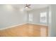 Relaxing bedroom with neutral walls, crown molding, hardwood floors, ceiling fan and two windows at 5575 Julian Pl, Atlanta, GA 30342
