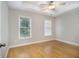 Cozy bedroom with two windows, hardwood floors, crown moulding, and ceiling fan at 5575 Julian Pl, Atlanta, GA 30342