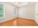 Bright, empty bedroom offers hardwood floors and a ceiling fan at 5575 Julian Pl, Atlanta, GA 30342