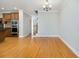 Open dining area with hardwood floors, leads to the kitchen and a staircase to the upper level at 5575 Julian Pl, Atlanta, GA 30342