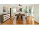 Formal dining room showcasing hardwood floors, wainscoting, and natural light from large windows at 5575 Julian Pl, Atlanta, GA 30342