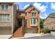 Charming brick townhouse with a front-facing garage and inviting staircase to the front door at 5575 Julian Pl, Atlanta, GA 30342