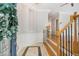 Welcoming foyer featuring tile flooring, stairs, hardwood floors, and elegant trim at 5575 Julian Pl, Atlanta, GA 30342