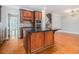 Well-equipped kitchen boasts rich wood cabinets, a center island, and stainless steel appliances at 5575 Julian Pl, Atlanta, GA 30342