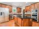 Gourmet kitchen with stainless steel appliances, granite countertops, and custom wood cabinetry at 5575 Julian Pl, Atlanta, GA 30342