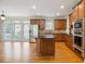 Modern kitchen with stainless steel appliances, granite countertops, and a central island for cooking at 5575 Julian Pl, Atlanta, GA 30342