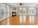 Cozy living room features a fireplace, hardwood floors, and lots of natural light from large windows at 5575 Julian Pl, Atlanta, GA 30342