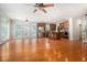 Spacious living area with hardwood floors and open layout to the kitchen, illuminated by natural light at 5575 Julian Pl, Atlanta, GA 30342