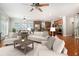 Bright living room boasts a ceiling fan, hardwood floors, with views to the kitchen and dining area at 5575 Julian Pl, Atlanta, GA 30342