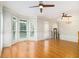 Open-concept living room with hardwood floors, large windows, and stylish ceiling fans at 5575 Julian Pl, Atlanta, GA 30342