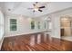 Bright main bedroom boasts large windows, trey ceiling, ceiling fan, and hardwood floors at 5575 Julian Pl, Atlanta, GA 30342