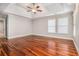 Light-filled main bedroom featuring trey ceiling, ceiling fan, and expansive hardwood flooring at 5575 Julian Pl, Atlanta, GA 30342