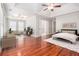 Sun-filled main bedroom featuring sitting area, trey ceiling, ceiling fan, and ensuite bathroom at 5575 Julian Pl, Atlanta, GA 30342