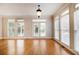 Sunlit room featuring hardwood floors, neutral paint, and multiple windows offering bright and airy space at 5575 Julian Pl, Atlanta, GA 30342