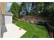 Landscaped backyard with a patio, green lawn, and privacy fence at 507 Bonneset Ct, Canton, GA 30114