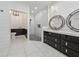Modern bathroom with double sinks, stylish mirrors, and a tiled shower at 507 Bonneset Ct, Canton, GA 30114
